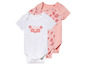 Een wit babypakje met een zon en palmbomen, twee roze babypakjes met bloemenprint
