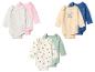 Six bodysuits bébé à manches longues de diverses couleurs et motifs (fleurs, chiens, abeilles).
