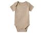 Un body bébé beige à manches courtes avec boutons-pression.