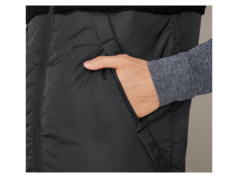 Een zwarte gewatteerde vest met rits en een zachte fleece voering