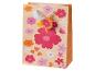 Sac cadeau avec motif floral coloré et poignée en ruban blanc.