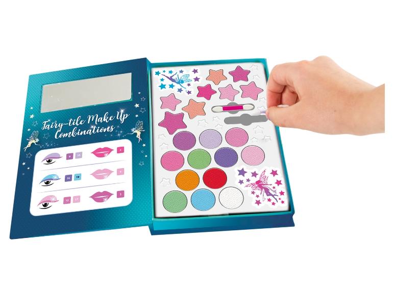 Une boîte de maquillage pour enfants avec des fards à paupières, du rouge à lèvres et des autocollants sur le thème des fées.