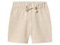 Short en jersey beige clair avec taille élastique et cordon de serrage décoratif.