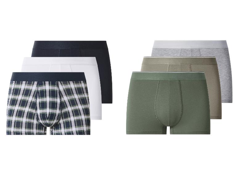 Vijf katoenen boxershorts: één geruit, één wit, één zwart, één kaki en één groen.