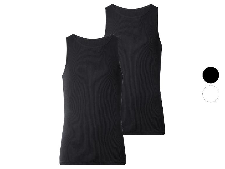 Twee zwarte geribbelde tanktops, één iets achter de andere, met kleurstalen.