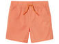 Un short orange avec cordon de serrage pour garçon.