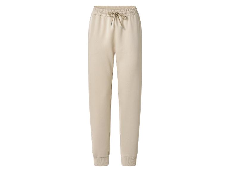 Pantalon de survêtement beige avec taille élastique et cordon de serrage.