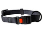Un collier pour chien noir avec une boucle orange et un anneau en métal.