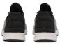 Une paire de chaussures de sport noires et grises à semelles blanches, vue arrière.
