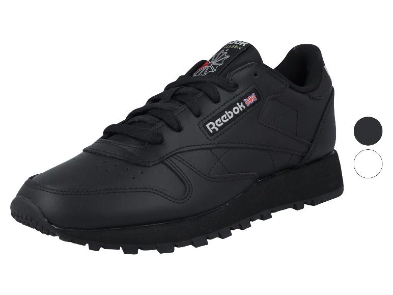 Zwarte sportschoenen met witte en grijze kleurkeuzecirkels.