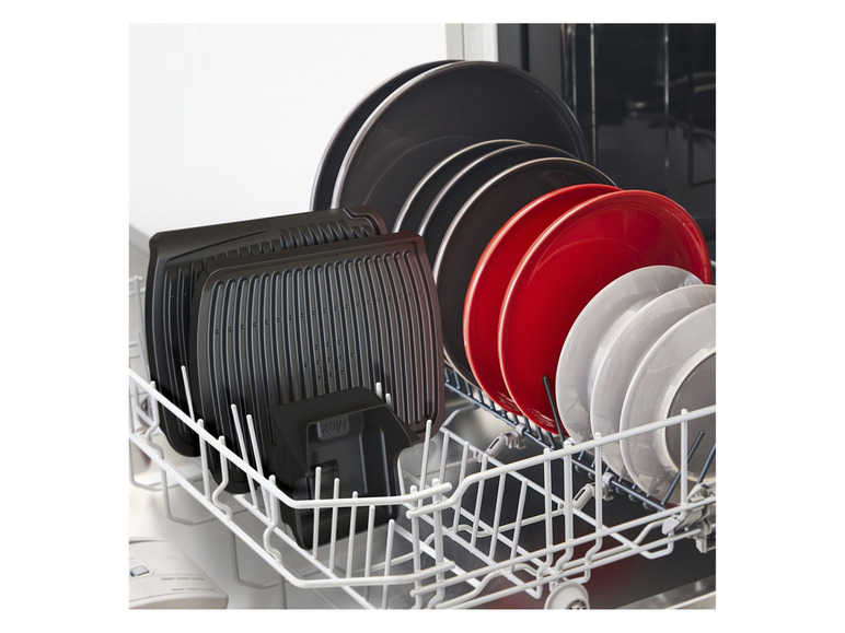 Un lave-vaisselle avec des plaques de grill noires et des assiettes rouges et grises.