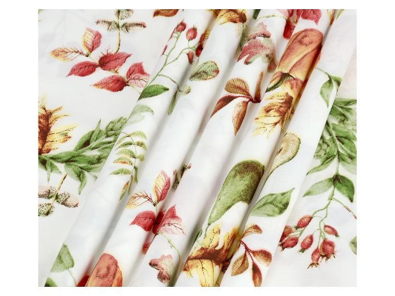 Tissu à motif floral dans les tons rouges, jaunes et verts.