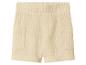 Short en mousseline beige avec taille élastiquée et poches.
