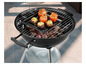Gevulde tomaten en champignons op een zwarte barbecue.