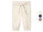 Pantalon en mousseline crème avec cordon de serrage et chevilles élastiques, avec options de couleurs.