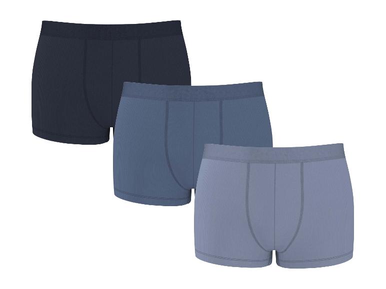 Trois boxers en coton côtelé dans des tons bleus et gris.