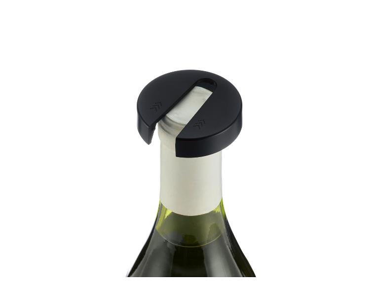 Zwarte wijndispenser op een fles witte wijn.