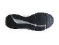 Dessous d'une semelle de chaussure de course noire et blanche avec un motif texturé.