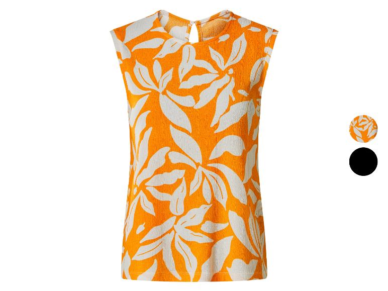Haut sans manches orange avec imprimé feuilles blanches et détails de couleur.