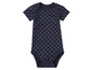 Een donkerblauwe baby romper met witte stippen.