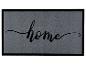 Paillasson gris avec bordure noire et le mot 'home' en écriture cursive.
