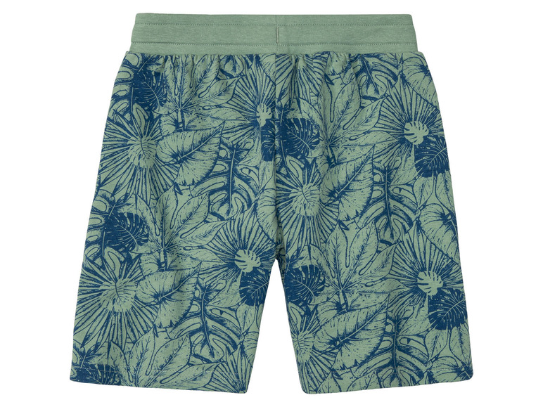 Shorts verts avec un motif de feuilles tropicales.