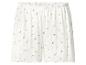 Short côtelé blanc avec un délicat motif floral rose et un ourlet volanté.