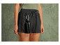 Zwarte shorts met een waterfles en een karabijnhaak.
