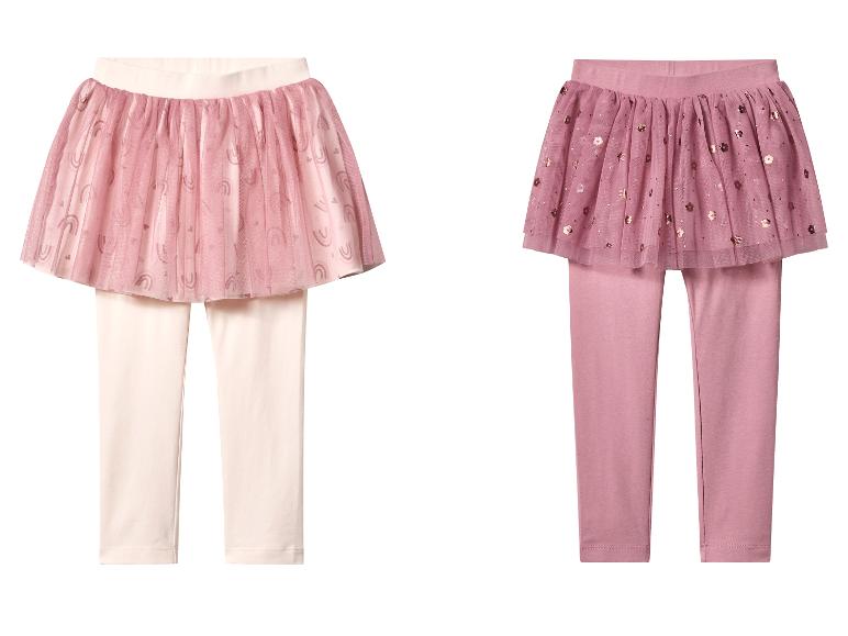 Deux paires de leggings-jupes pour enfants, un rose clair avec imprimé arc-en-ciel, un rose foncé avec des sequins floraux.