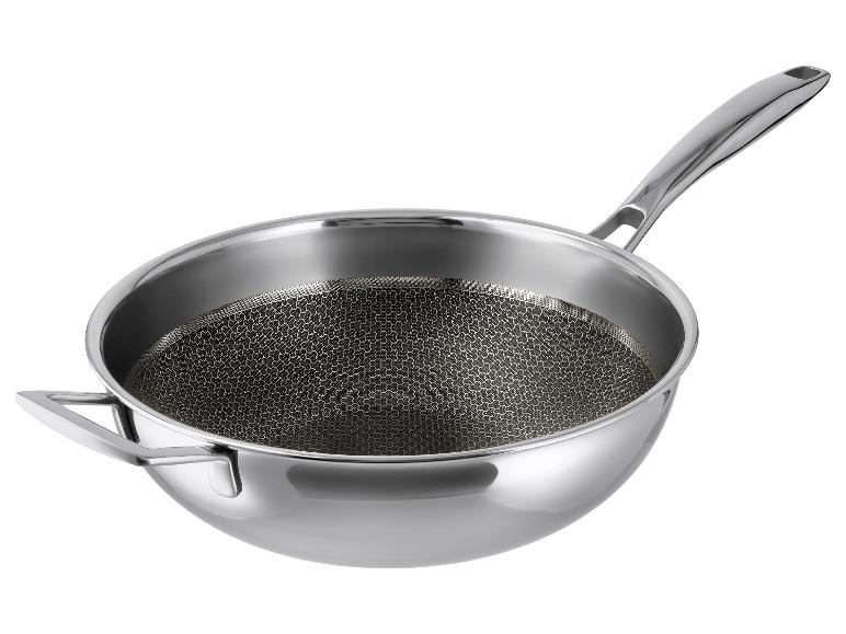 Wok en acier inoxydable avec longue poignée et poignée auxiliaire, avec intérieur texturé.
