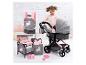 Een roze kinderwagen met een wieg, draagzak en accessoires voor poppen.