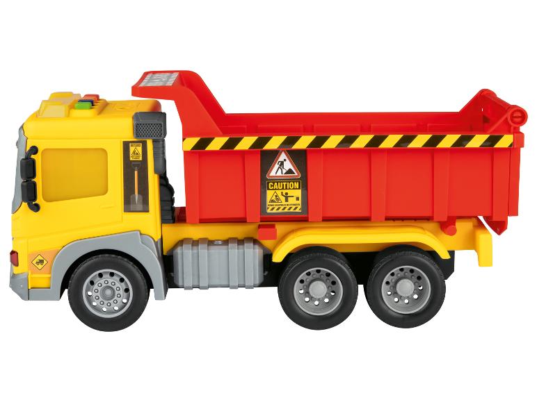 Camion benne jouet jaune et rouge avec panneaux d'avertissement