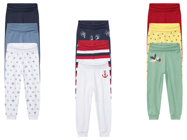 Zeven verschillende leggings voor kinderen met verschillende patronen, waaronder een anker, een zeemeeuw en aardbeien.