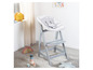 Une chaise haute Stokke Tripp Trapp grise avec un revêtement doux gris.