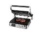 Elektrische grill met twee steaks die op de roosters worden gegrild, met open deksel en bedieningspaneel.