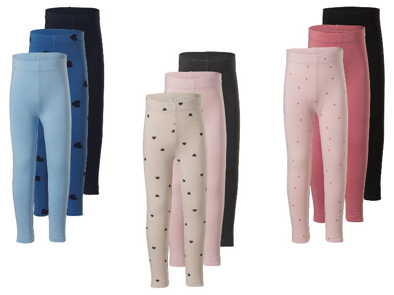 Lot de 9 leggings pour enfants en différentes couleurs et motifs, y compris des cœurs et des pois.