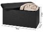 Banc de rangement noir avec couvercle ouvert et couverture roulée, mesurant 76x37,5x37,5cm.