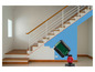 Un niveau laser vert projette une ligne rouge sur un escalier en bois.