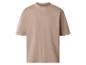 T-shirt beige ample à manches courtes.