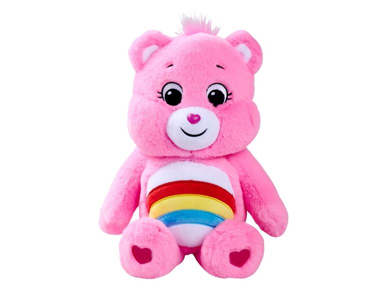 Une peluche Ourson Câlin rose avec un arc-en-ciel sur le ventre.