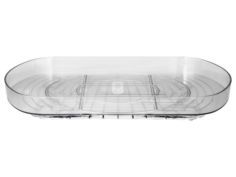 Égouttoir transparent avec insert de grille amovible.
