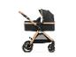 Poussette bébé noire et dorée avec nacelle et poignée réglable