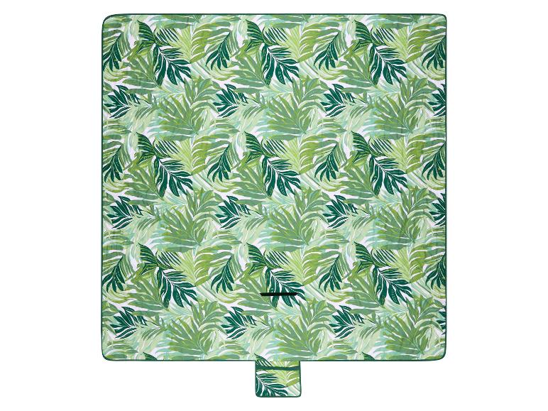Groene picknickdeken met tropisch bladpatroon.