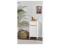Witte kast met lade en deur, een rieten mand en decoratie.