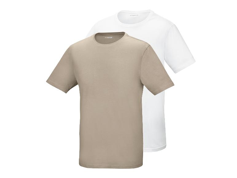 Twee T-shirts met korte mouwen, één beige en één wit, op elkaar gestapeld.