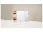 Miroir cosmétique triple blanc avec lumières LED et reflet d'yeux se maquillant.