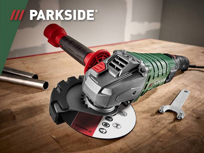 Een groene en grijze Parkside haakse slijper op een houten ondergrond.