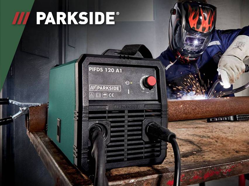 Een Parkside lasapparaat op een werkbank met een lasser op de achtergrond