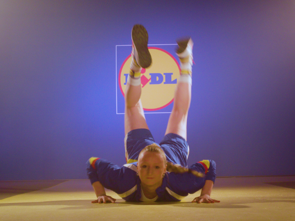 Femme faisant du breakdance devant le logo Lidl.