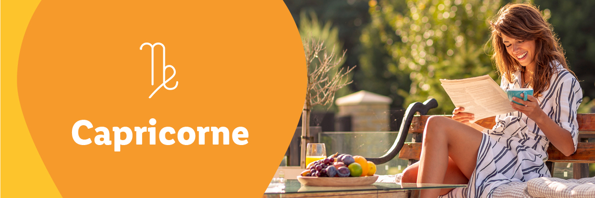 Capricorne : Femme se relaxant, lisant et savourant des fruits.